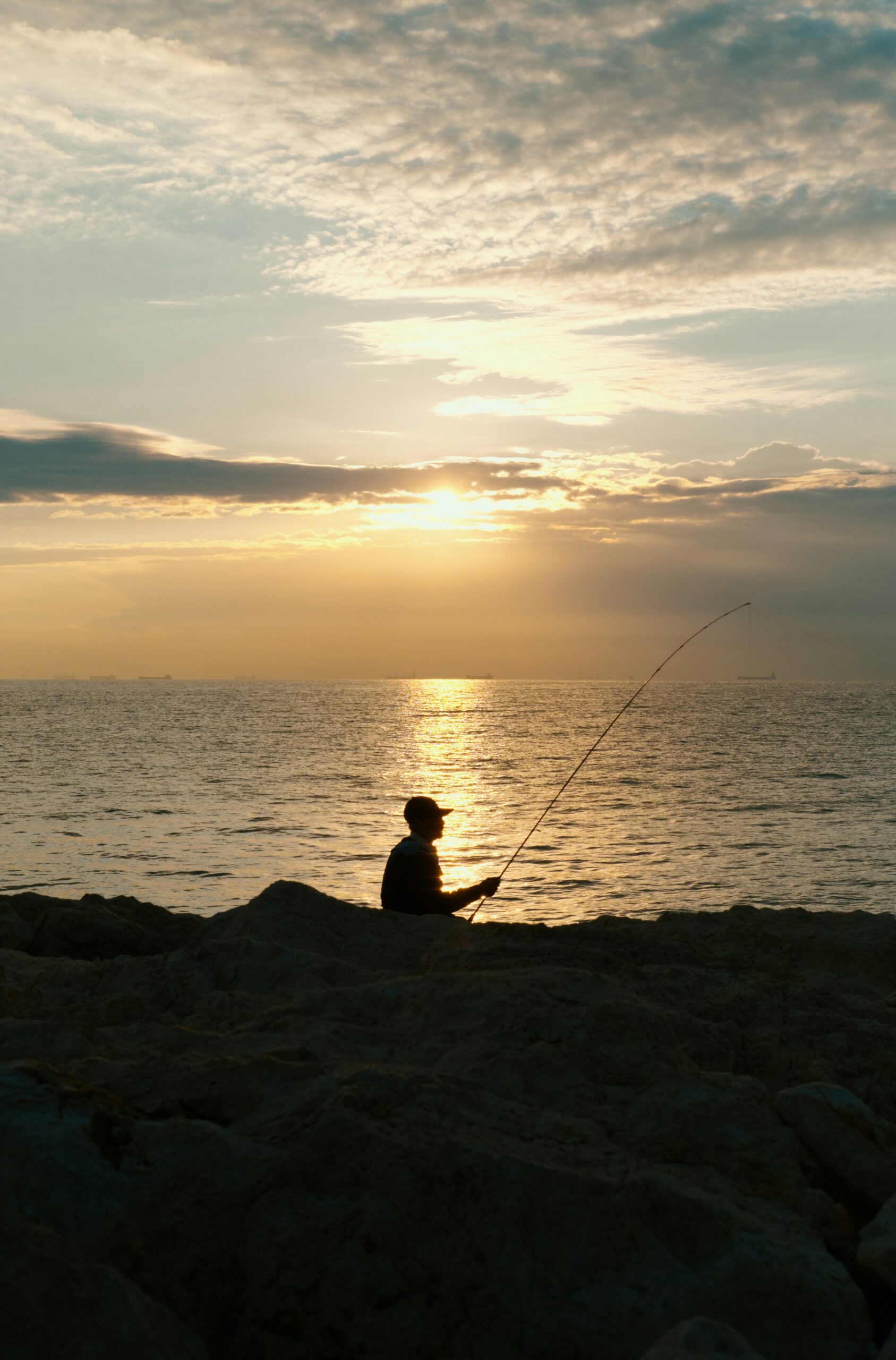 休職中の釣り、夕日の中でリラックスする人